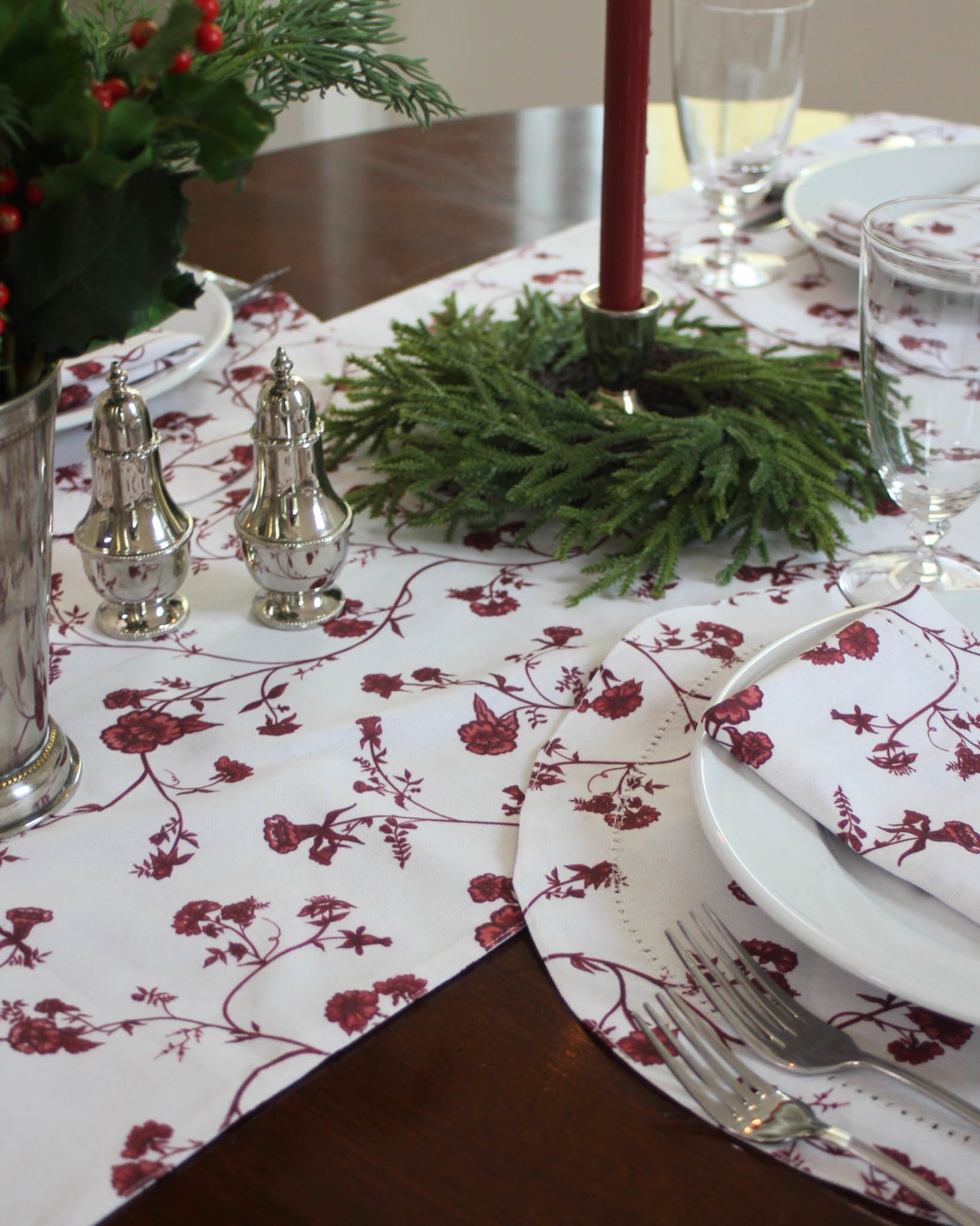 Decorative holiday table setting with red floral table table runner perfect for Christmas lunch or dinner with family and friends. Available in two sizes.