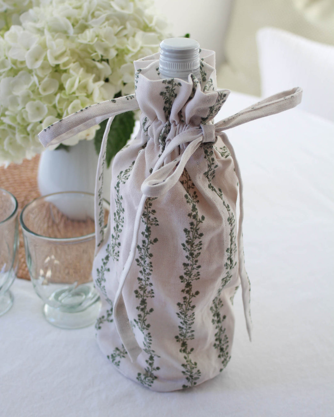 Green stripe floral wine bag in cotton with drawstring closure, perfect for hostess and holiday gifting.