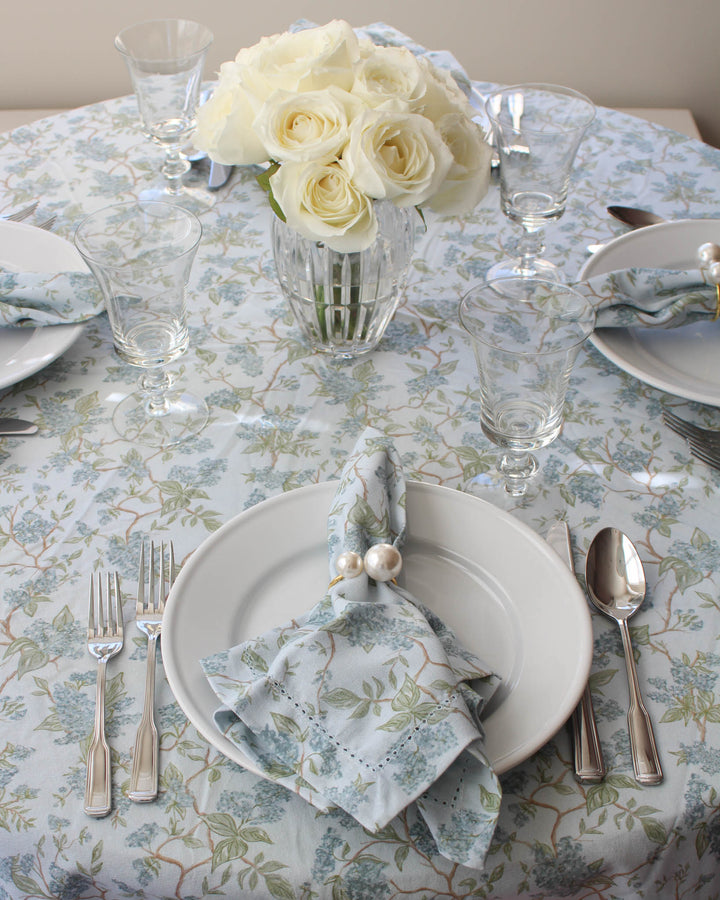 Chinoiserie inspired floral tablecloth in blue and green, crafted from 100%  cotton for elegant spring hosting. This round wedding tablecloth is perfect for rehearsal dinners, Easter table settings, or Mother’s Day gatherings. Designed in Charleston and ethically made in India using non-toxic dyes, it brings French country charm and farmhouse warmth to any table.