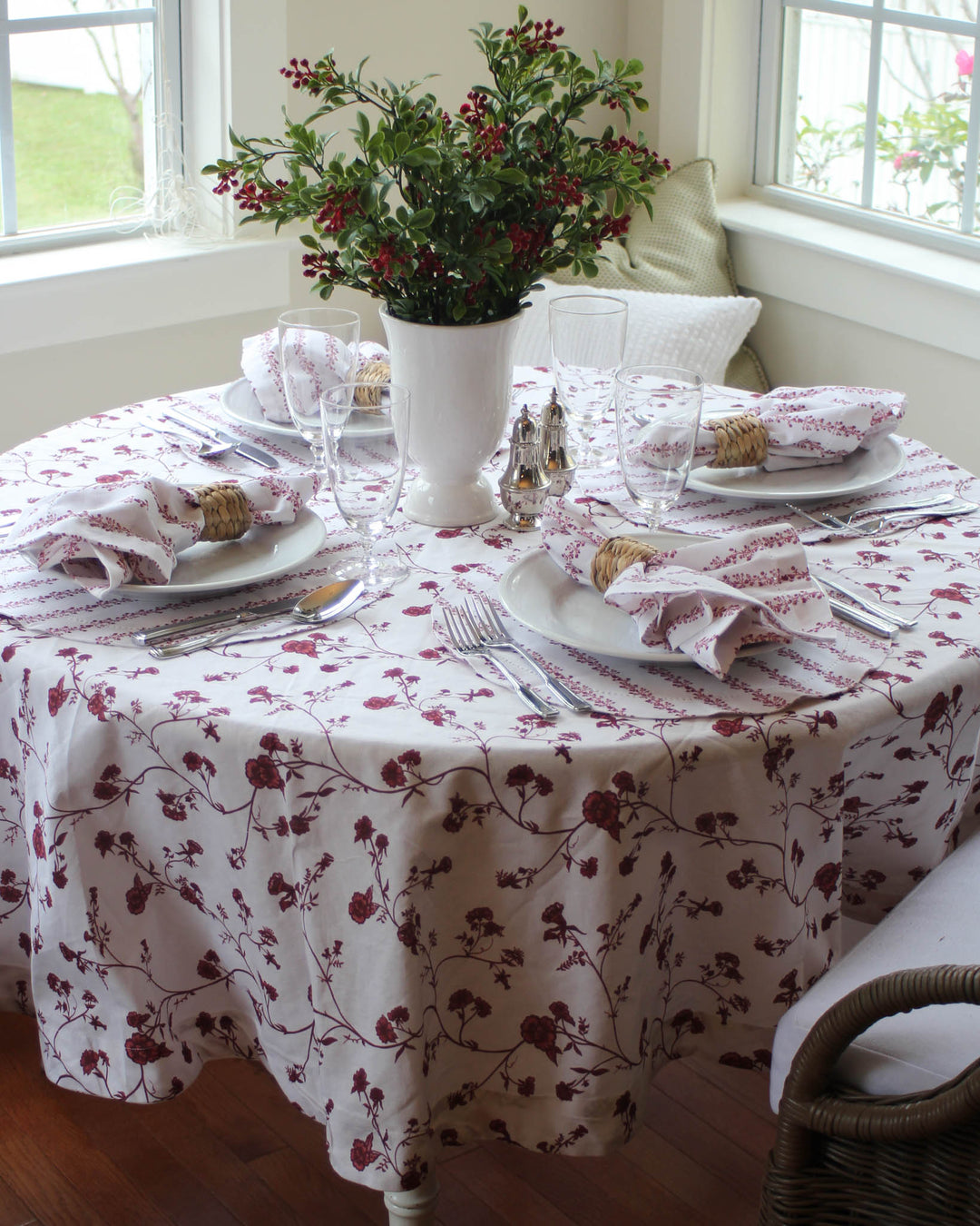 Organic cotton Garden Vine tablecloth with botanical print draped on round dining table for festive Christmas breakfast gathering