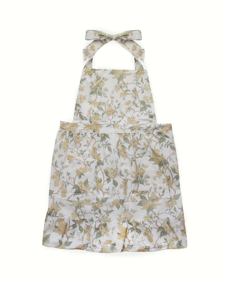 Celebrate spring with this exquisite yellow floral smock apron dress featuring a ruffle hem. Made from premium 100% cotton, it includes two pockets and adjustable ties, perfect for a ruffle cooking apron or gardening apron. This baking apron for women is an ideal Mother's Day gift for mom or a thoughtful Easter hostess gift. Its grand millennial decor style and vibrant floral print make it a staple for spring summer entertaining and making special holiday memories together.