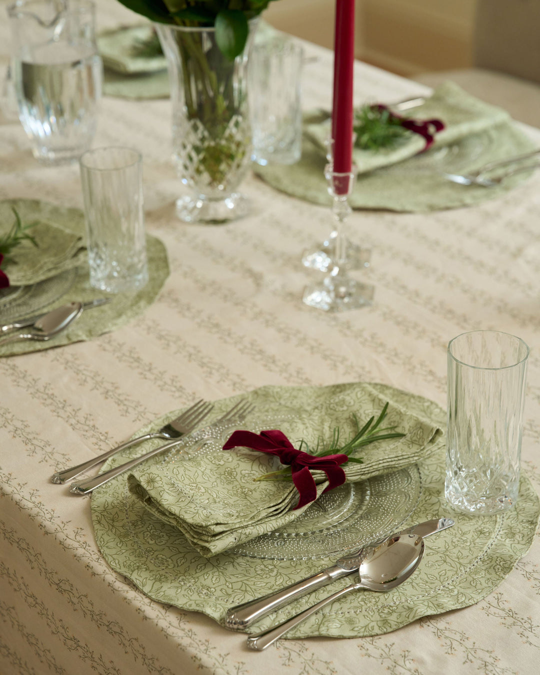 Sage green cotton placemats featuring a hand-drawn botanical print for an elegant Christmas table setting and holiday entertaining.