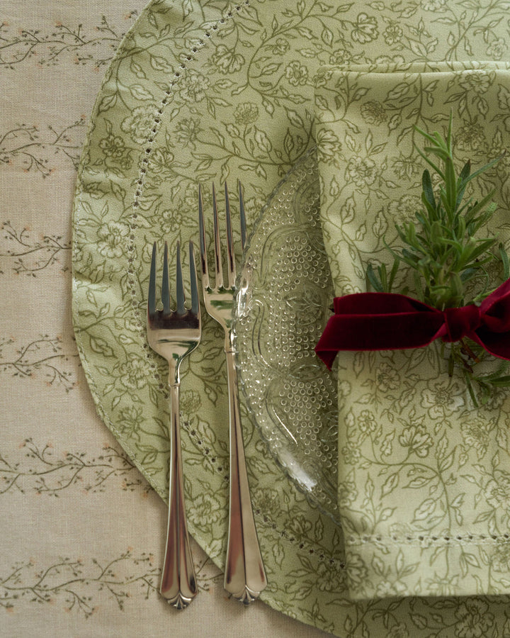 Willamere sage green floral cotton placemats styled for holiday entertaining, creating a beautiful and timeless Christmas table setting.