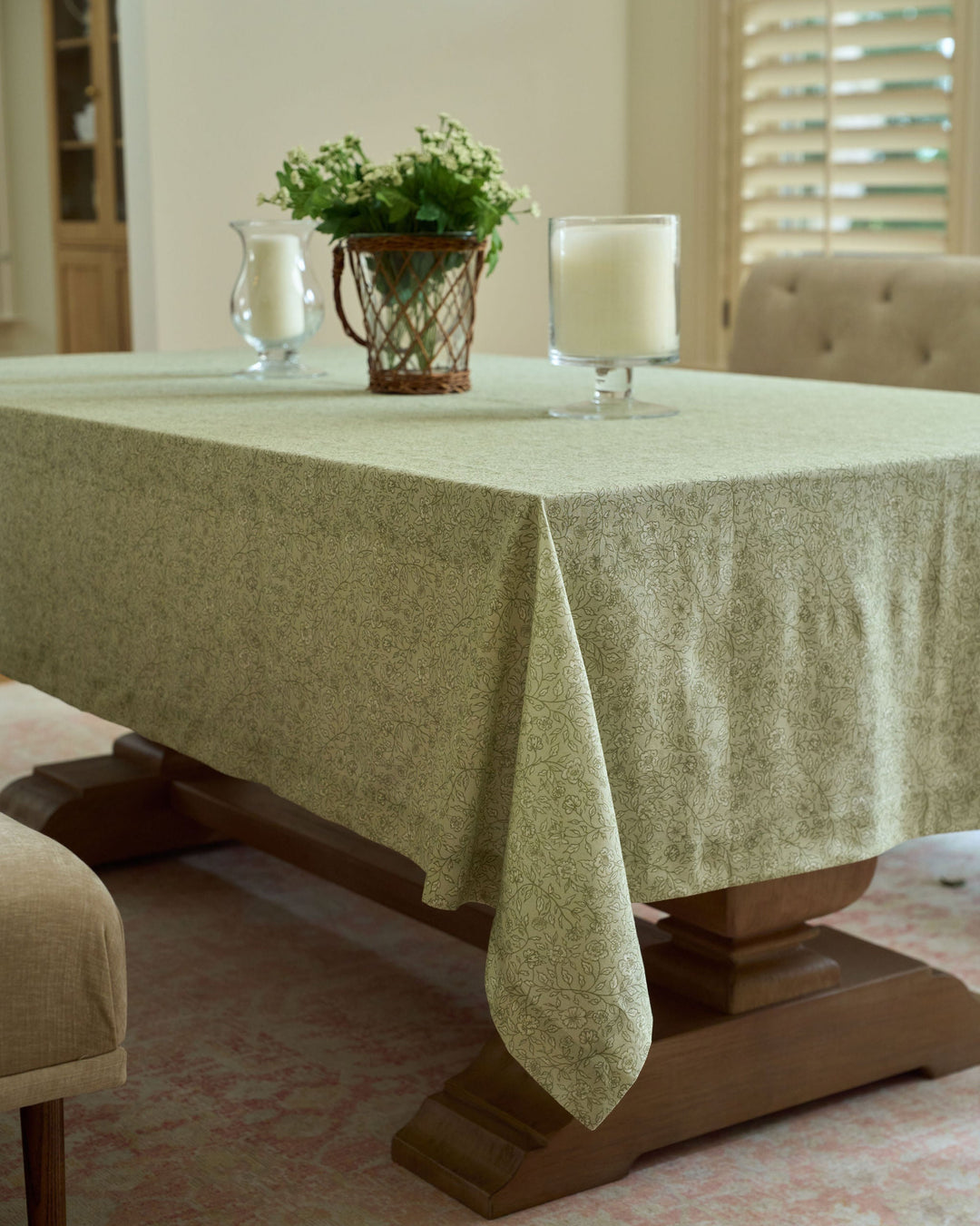 Sage green and brown botanical tablecloth styled for a spring wedding, featuring neutral floral table linens, English garden details, and elegant reception decor.