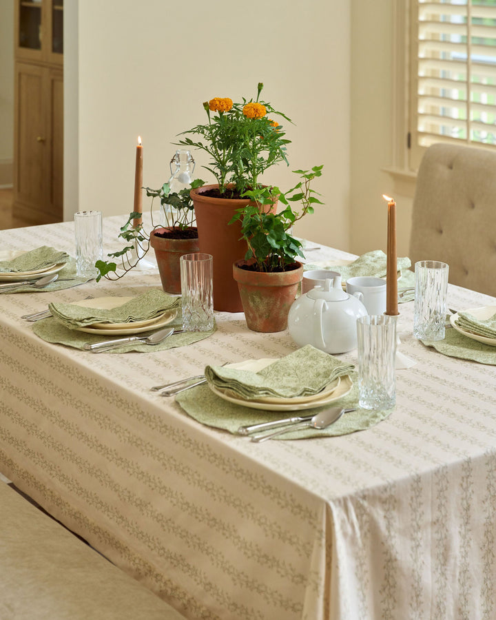 Cream floral stripe tablecloth with sage green, muted yellow, and tan botanicals for spring celebrations, Easter, fall hosting, and Thanksgiving.