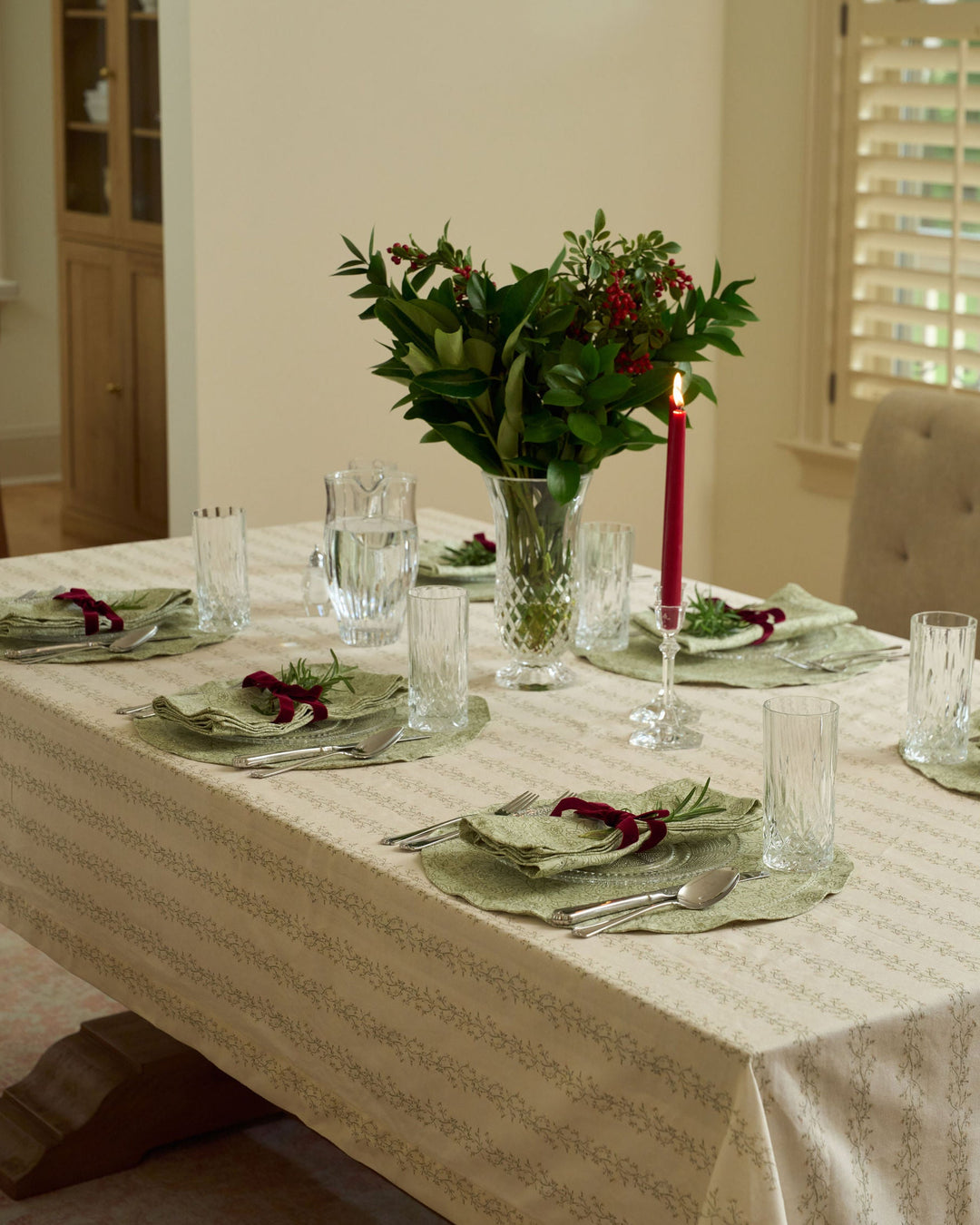 Sage green botanical placemats styled for a traditional Christmas table, bringing soft green tones and timeless elegance to holiday gatherings.