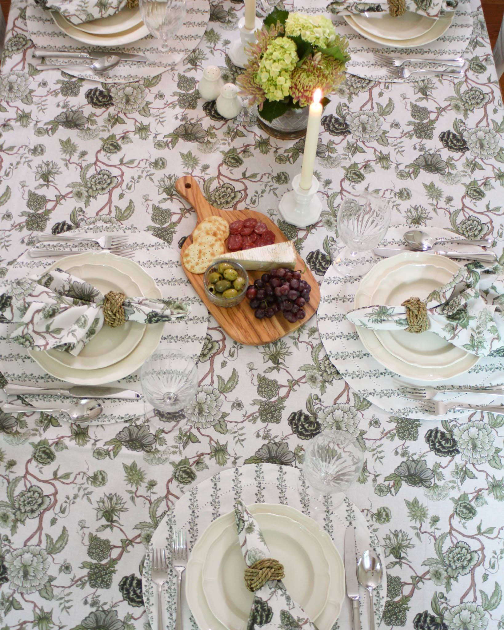 Green floral organic cotton tablecloth with hand-drawn floral design styled for a cozy fall dinner