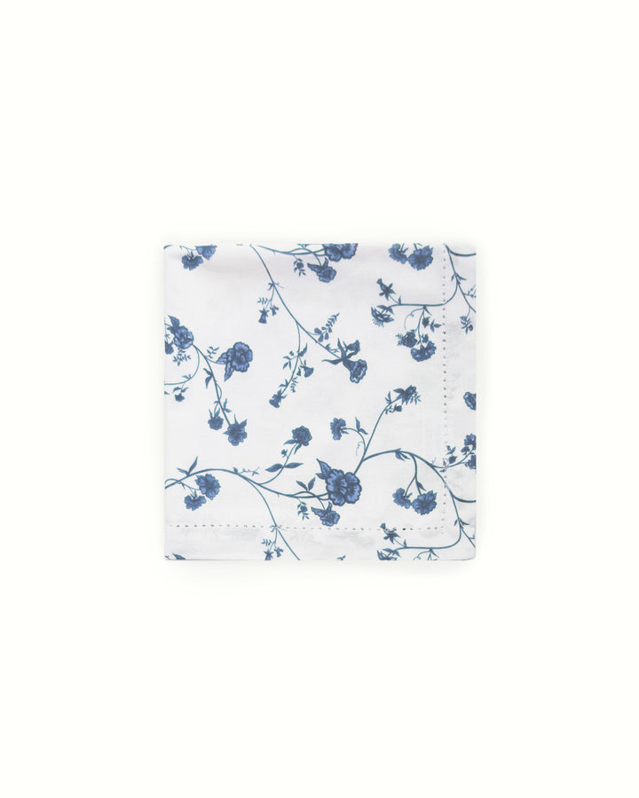 Blue floral patterned cotton napkins on a white background