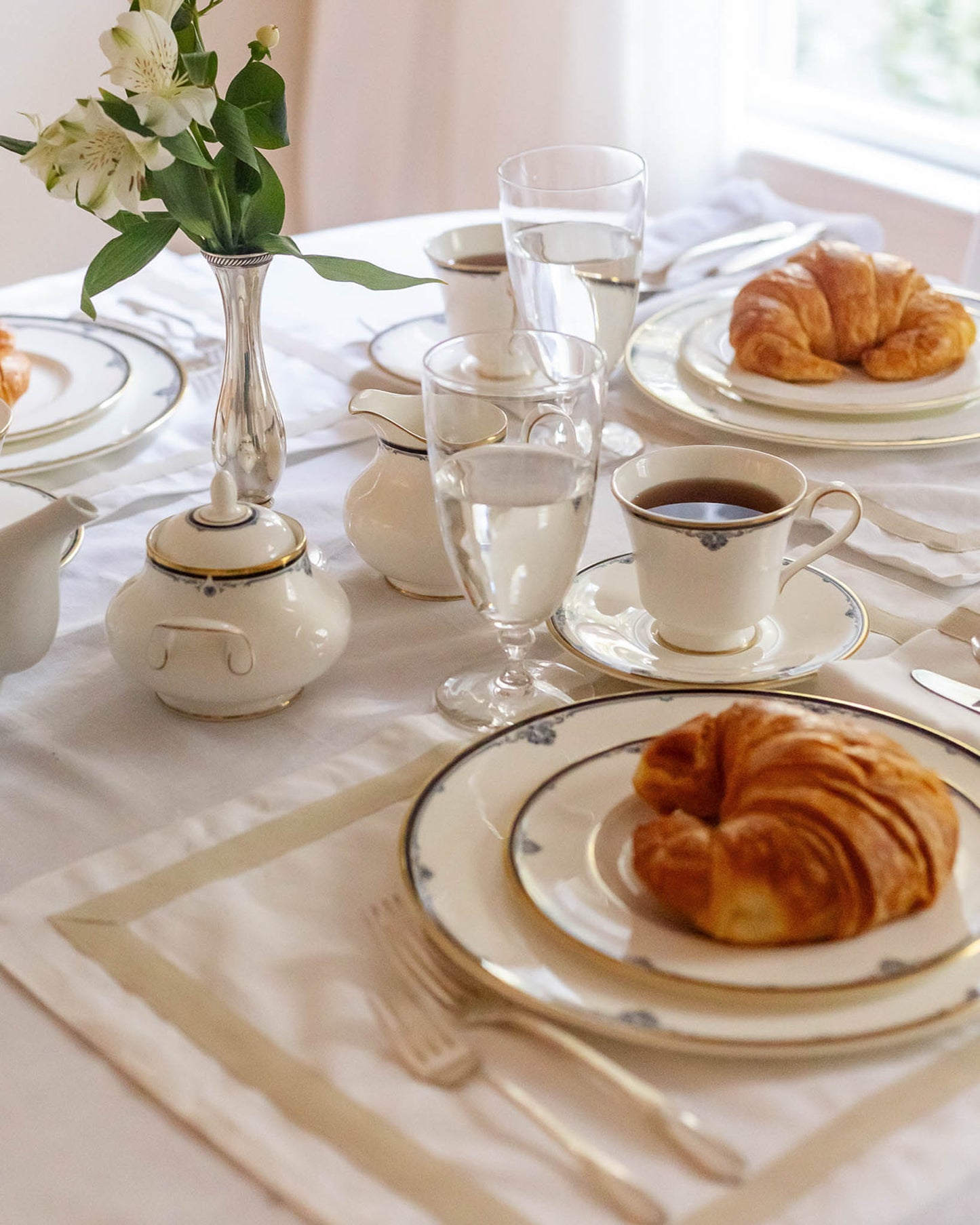 White table linens with beige border perfect for spring and summer hosting, wedding gifts, and brunches.