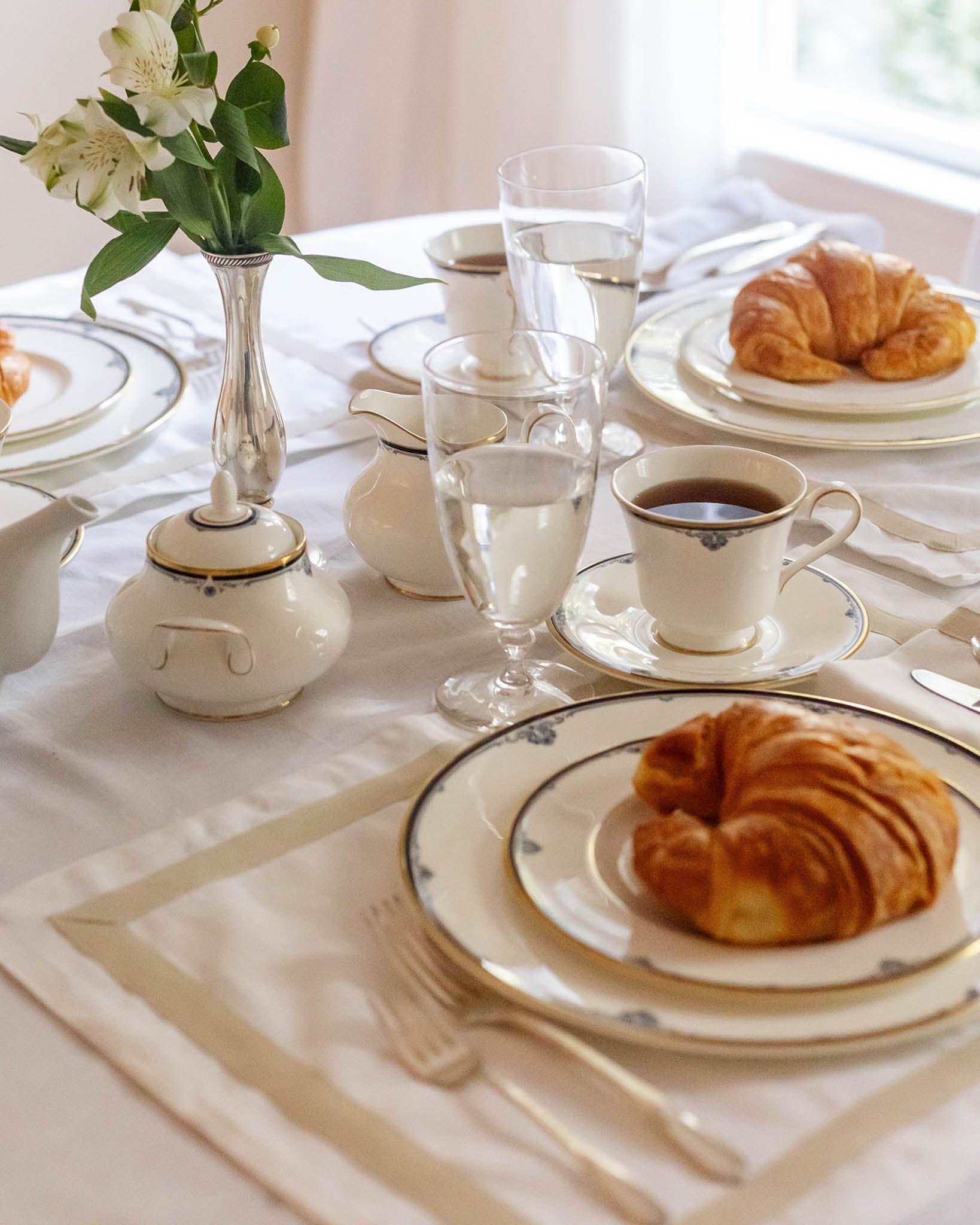 White table linens with beige border perfect for spring and summer hosting, wedding gifts, and brunches.