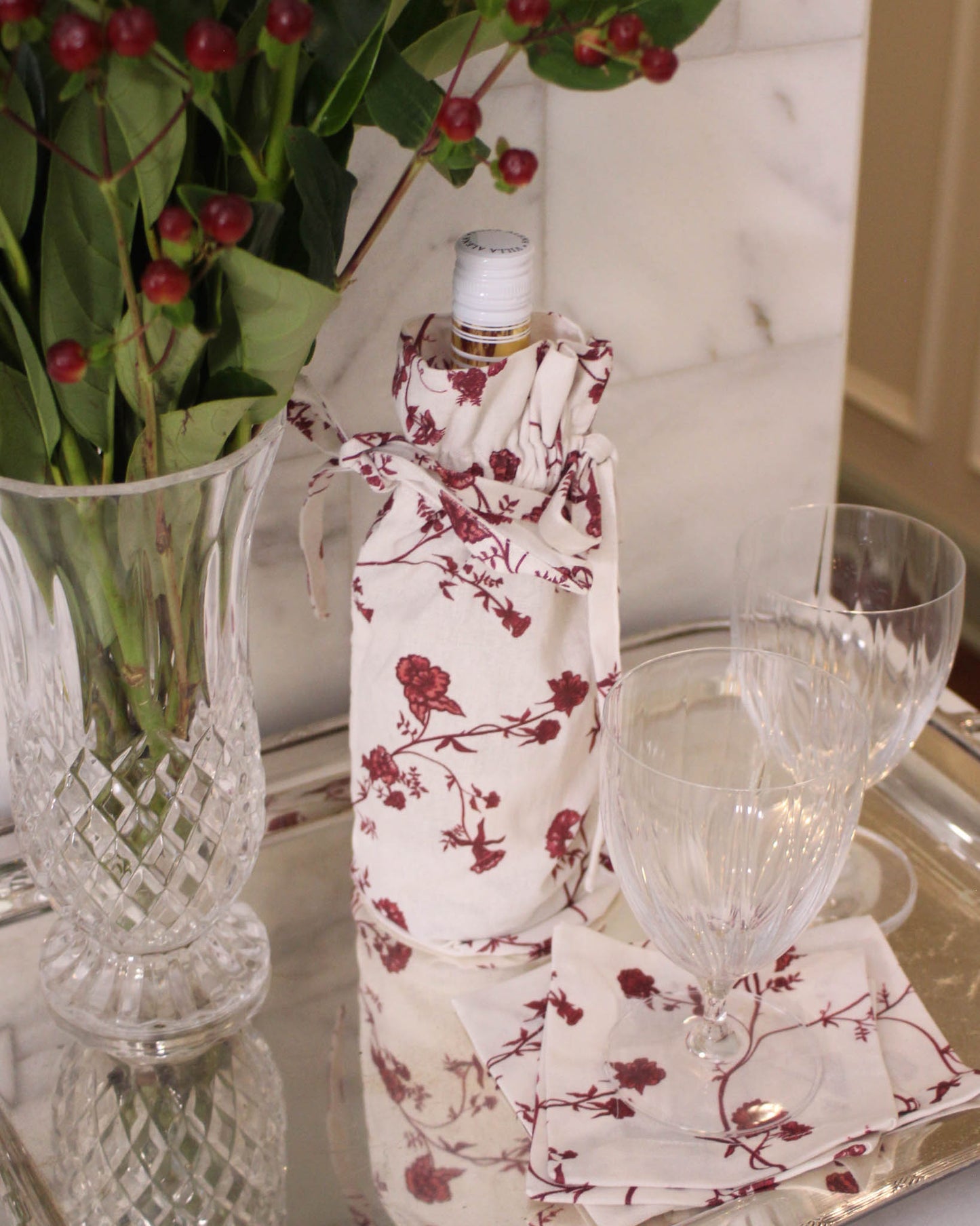 Festive floral wine bag with drawstring closure, perfect for wrapping a favorite bottle.