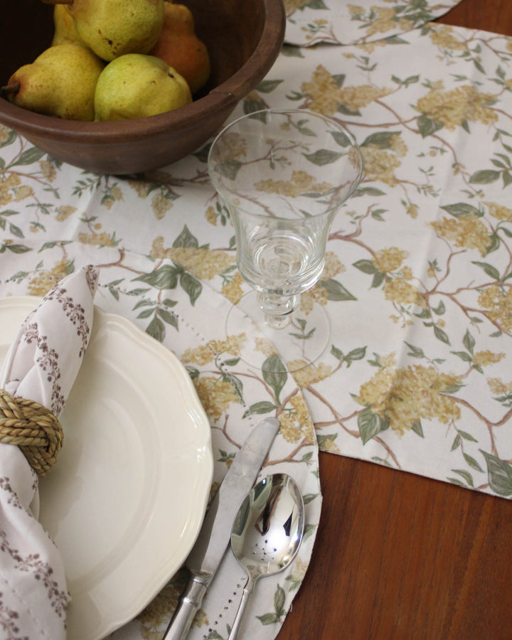 The ideal Mother’s Day gift for mom, grandma, or a hostess who loves to entertain. This floral cotton table runner showcases a charming yellow and green botanical print with a hint of earthy brown. Available in generous 104" and 120" sizes, it’s perfect for a Mother’s Day brunch or garden-themed dinner party. Made from soft, 100% organic cotton that becomes more beautiful with every wash. A thoughtful, elegant gift for her that brings the beauty of spring indoors all year long.