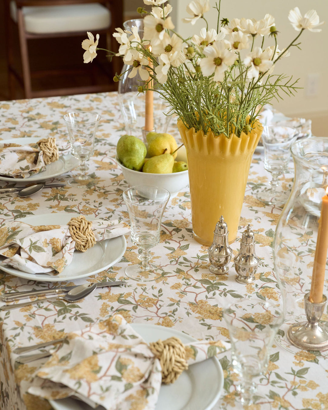 Hyacinth Marigold yellow cotton napkins with a timeless floral print, folded beside classic dinnerware for an elegant fall or Thanksgiving table.