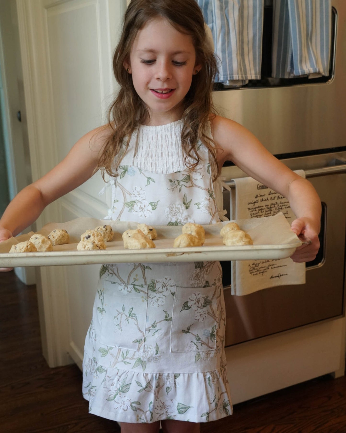 Adorable ruffle apron for little girls in the Camellia floral print, ideal for baking, cooking, and crafting. Perfect little girl birthday gift.