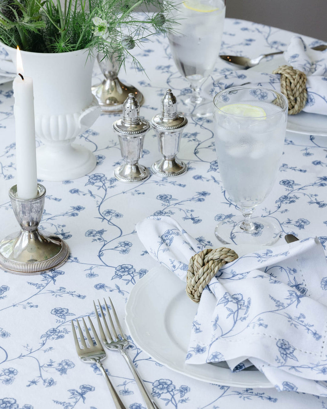 Hand-drawn Garden Vine floral tablecloth draped over a dining table with matching dinner napkins, creating a fresh grand millennial look for everyday meals or hosting.