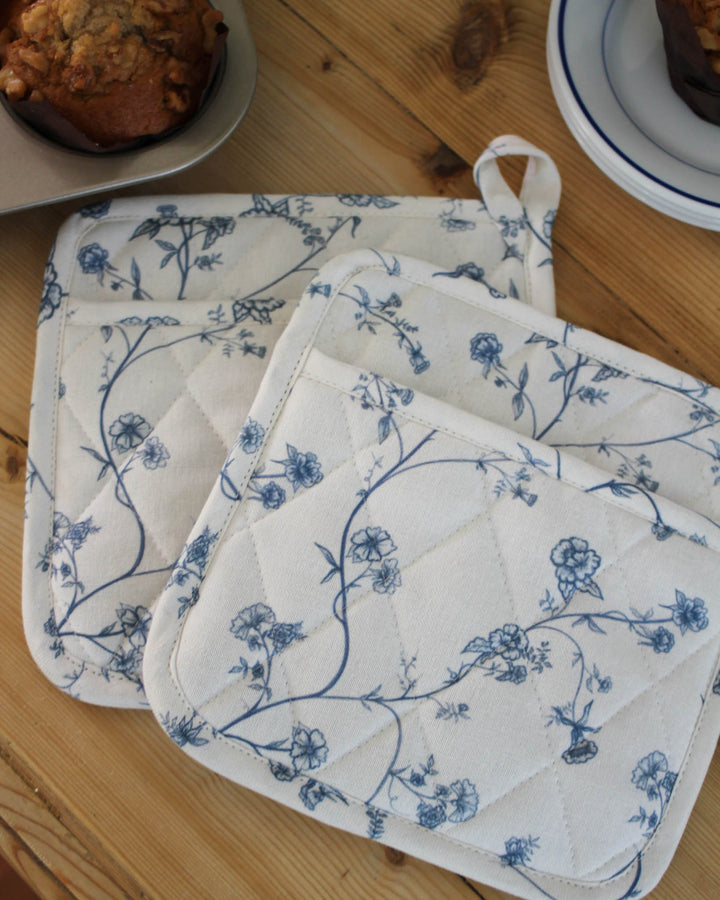 Garden Vine cotton pot holders, set of 2, featuring a hand-drawn blue floral print and insulated lining for safe kitchen use.