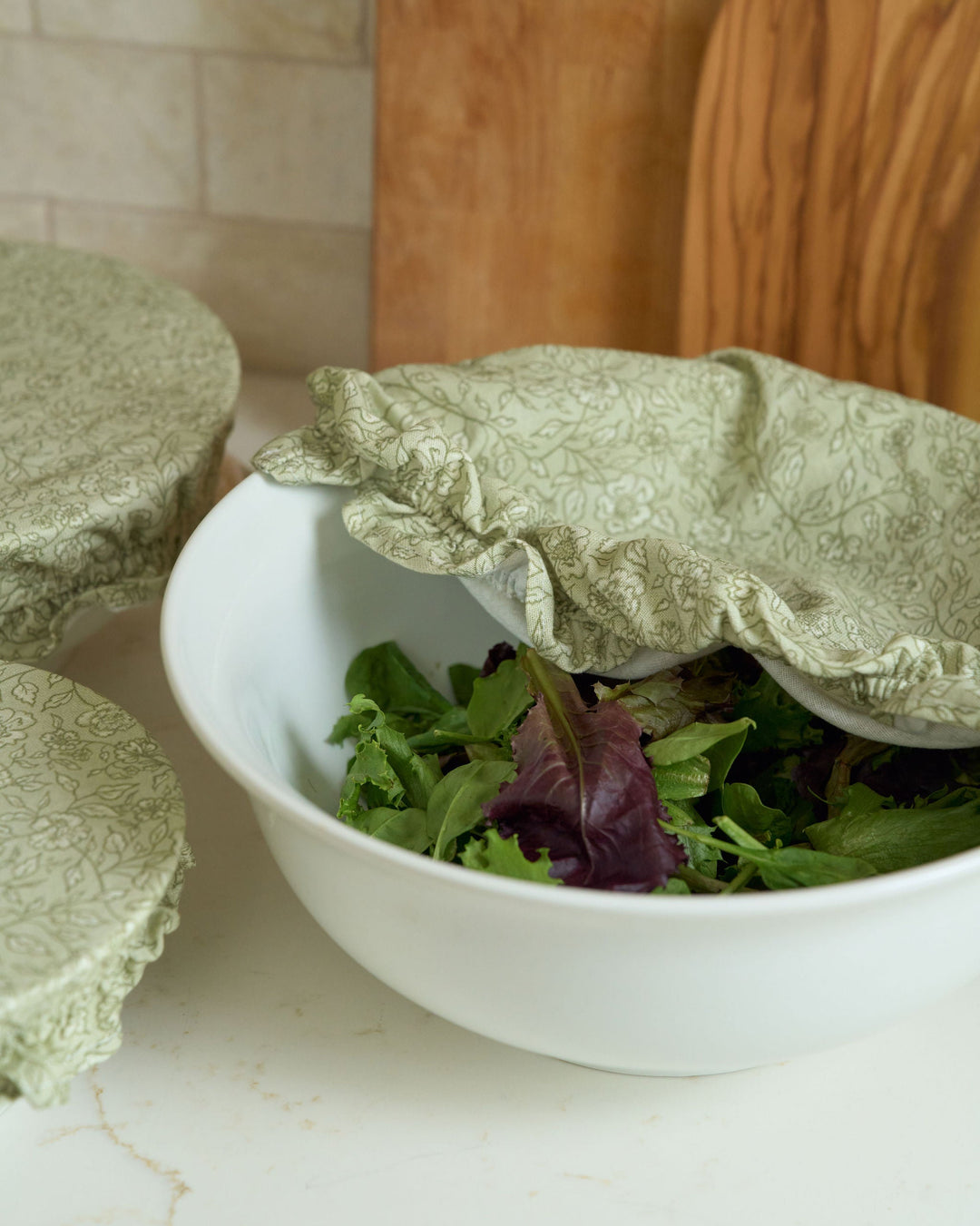 Garden Fields cotton bowl cover set in a hand-drawn sage floral print, featuring three practical reusable sizes for covering dough, proofing sourdough, storing food, preparing dishes ahead, fall cooking, Thanksgiving hosting, Christmas baking, spring brunches, summer entertaining, and plastic-free kitchens.