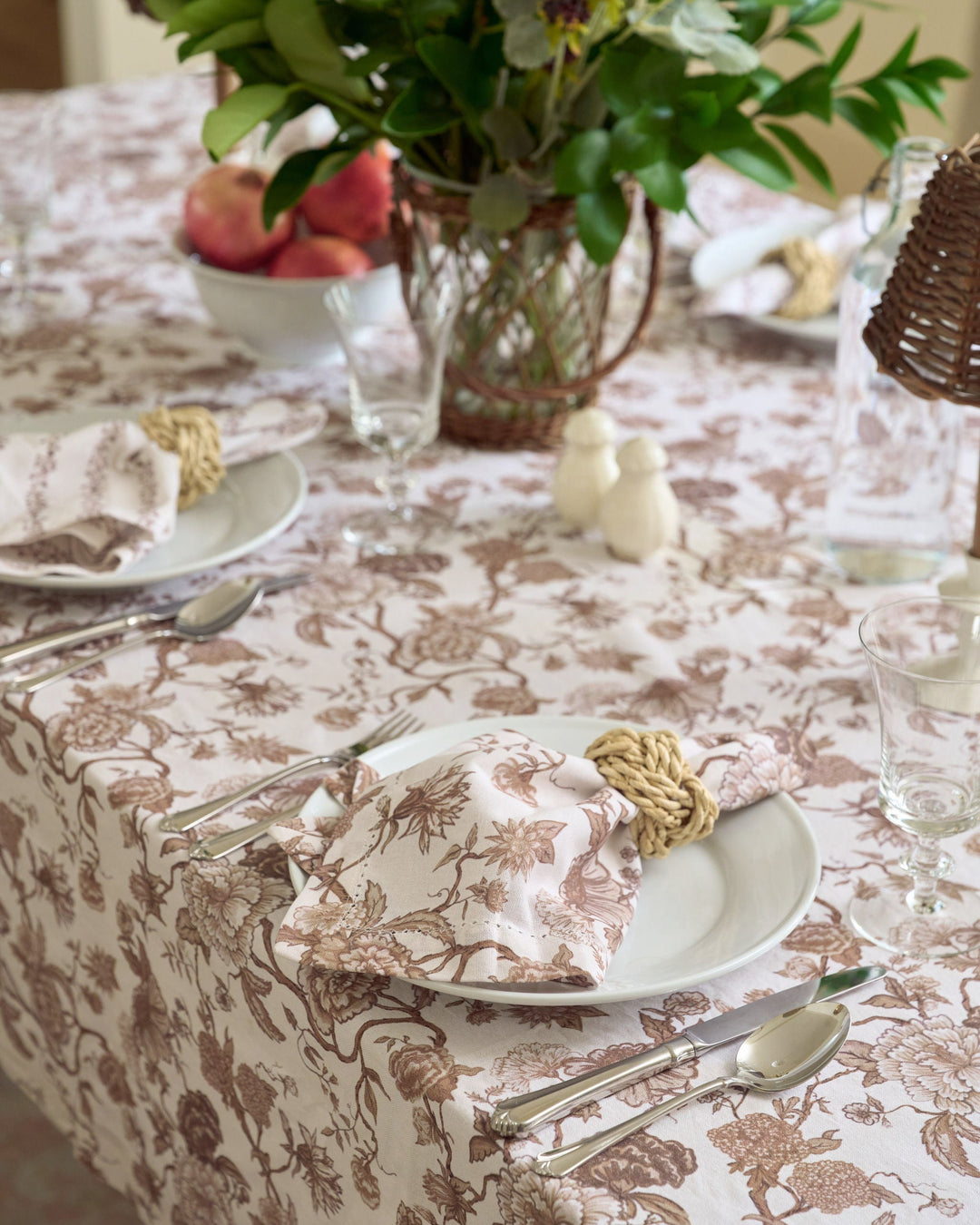 Chocolate brown floral cotton napkins folded beside classic dinnerware for warm autumn dinners, Thanksgiving hosting, and everyday dining.
