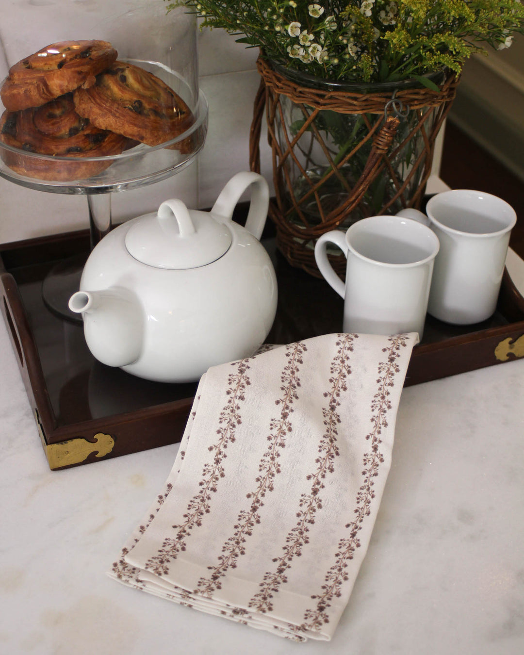 Brown floral stripe tea towel with hand-drawn botanical details, a timeless kitchen linen for fall hosting, everyday cooking, and gifting.