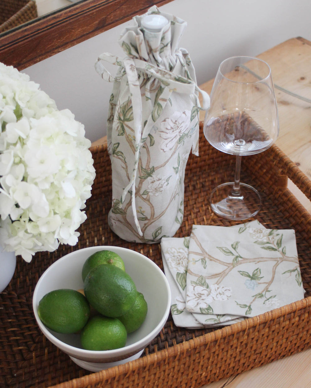 Reusable floral wine bag designed for gifting wine, olive oil, or homemade treats at gatherings.