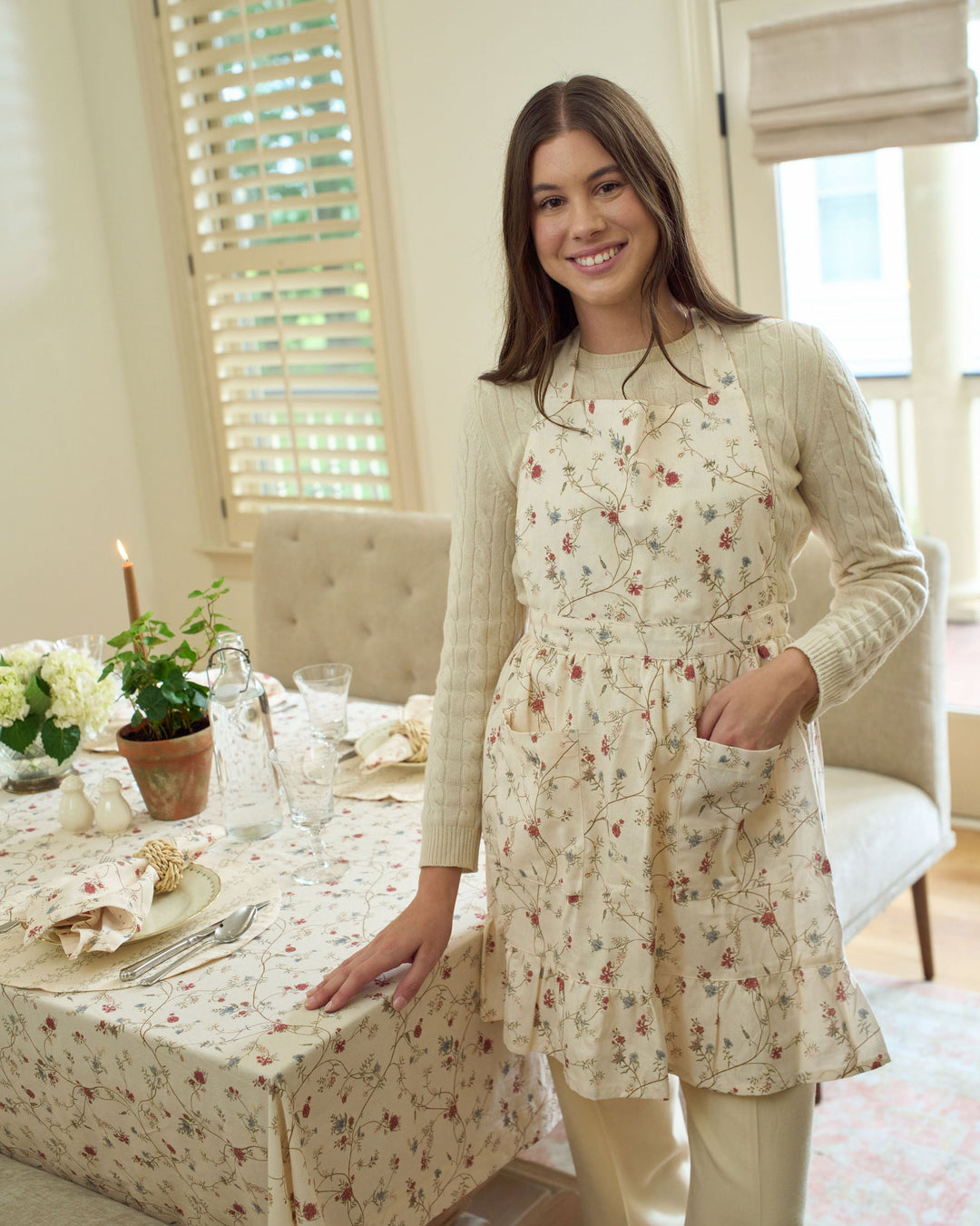 Antique Floral cotton apron with front pockets, ruffle detailing, gathered waist, and adjustable ties, styled for everyday cooking, fall baking, Thanksgiving dinner preparation, Christmas baking, holiday hosting, hostess gifts, and year-round kitchen use.