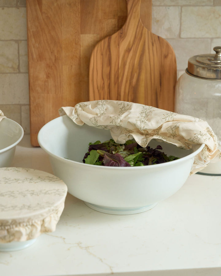 Cream floral stripe cotton bowl covers in three reusable sizes with soft elastic edges and decorative ruffle details, designed for covering dough, storing food, preparing dishes ahead, protecting serving bowls, holiday baking, hostess gifts, housewarming gifts, and year-round kitchen use.