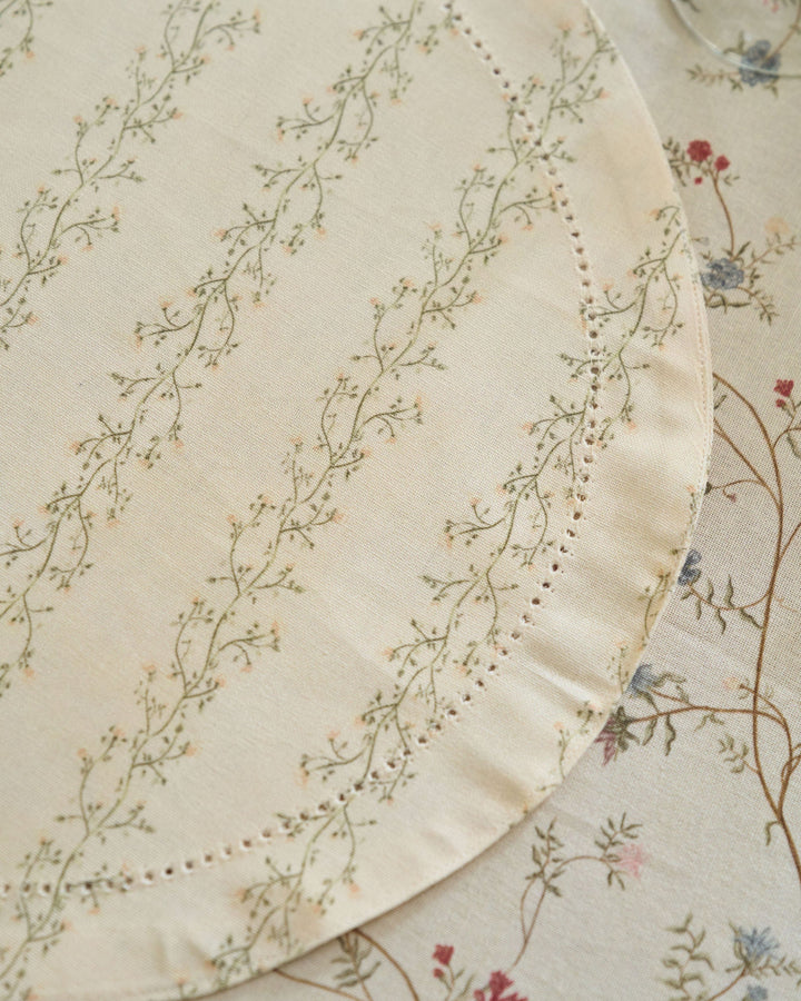 Neutral cream striped placemats featuring a green and yellow floral print for spring celebrations, autumn entertaining, and Thanksgiving dinner.