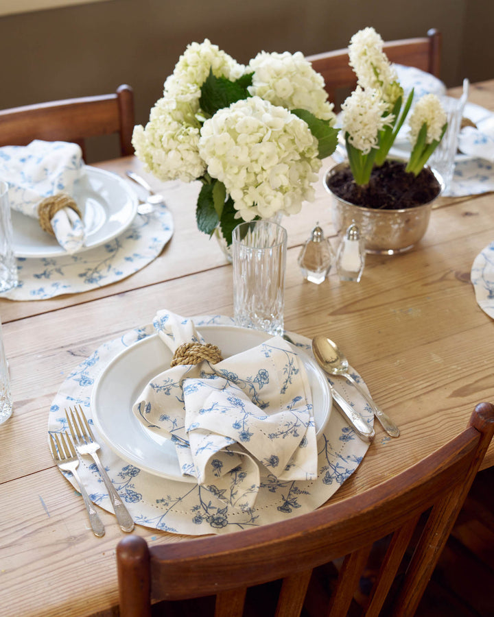 Garden Vine placemats in Delft Blue, set of 4 in hand-drawn blue and white Charleston print, crafted from 100% cotton with hemstitch detail for elegant everyday dining.