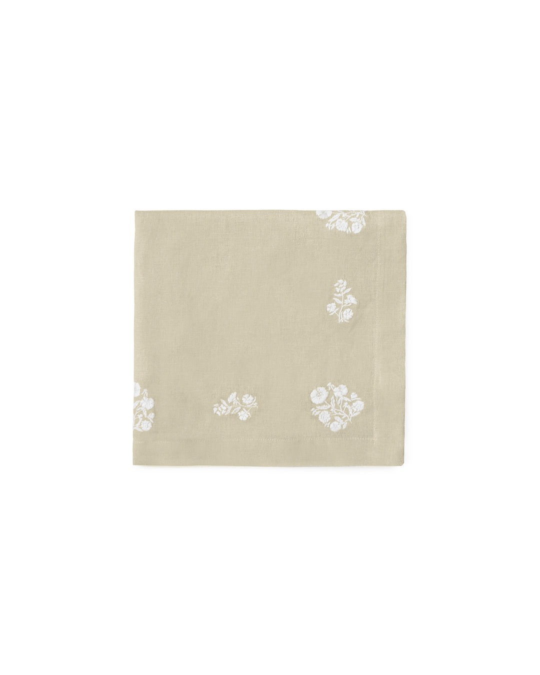 Showcasing a natural beige linen-cotton blend, these embroidered napkins are a staple for country-style hosting. This set of 4 features white floral motifs that pop against the neutral fabric. Styled here with a woven rope napkin ring and white scalloped plates, they offer a tactile, layered look for an Easter garden party. These 20x20 napkins are durable yet elegant, making them an ideal housewarming gift for someone who loves a clean, botanical-inspired spring aesthetic.