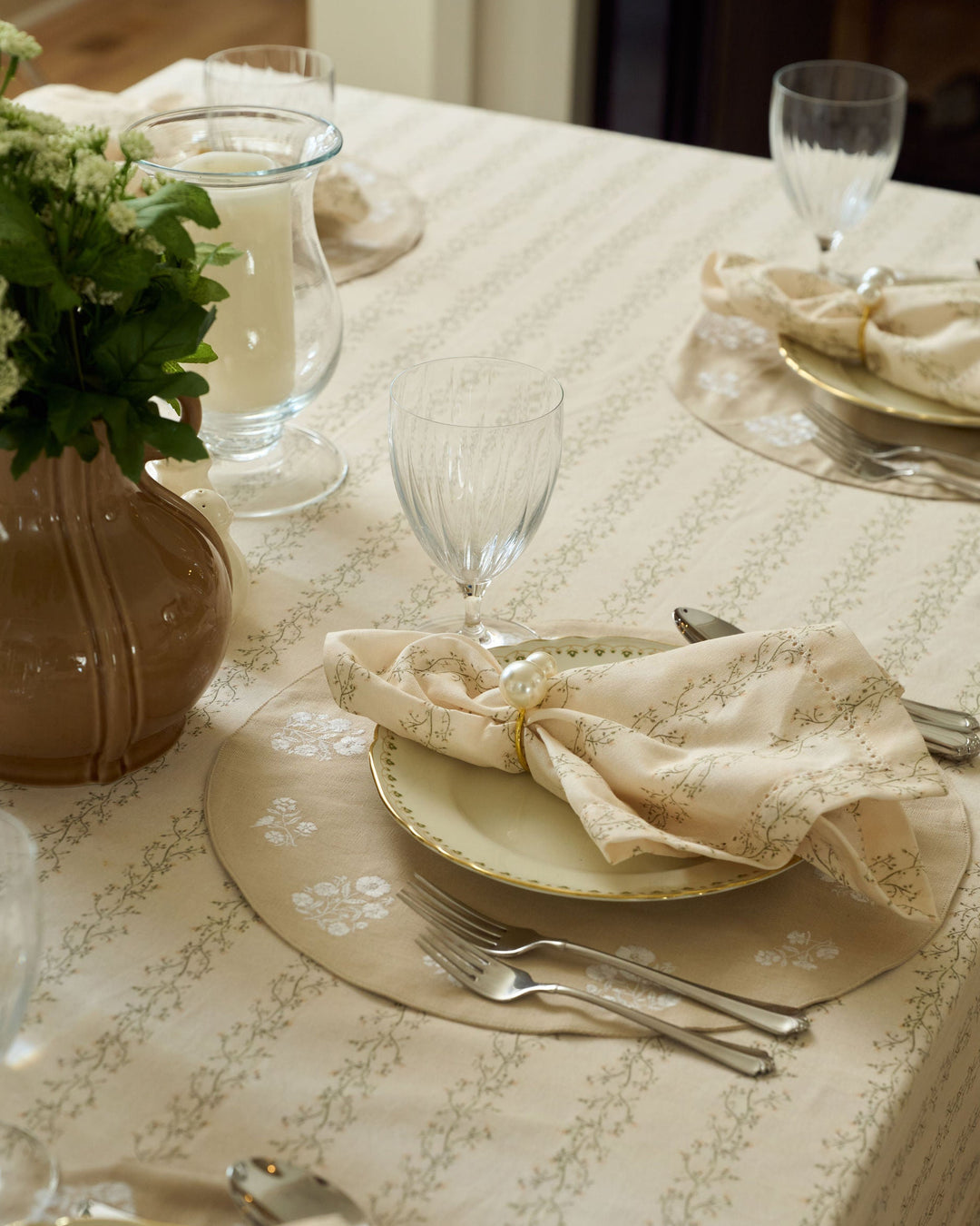 Meadow Stripe cloth napkins with a cream background, moss green florals, and pale yellow details for spring, Easter, fall, and Thanksgiving tables.
