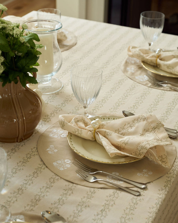 Meadow Stripe cloth napkins with a cream background, moss green florals, and pale yellow details for spring, Easter, fall, and Thanksgiving tables.