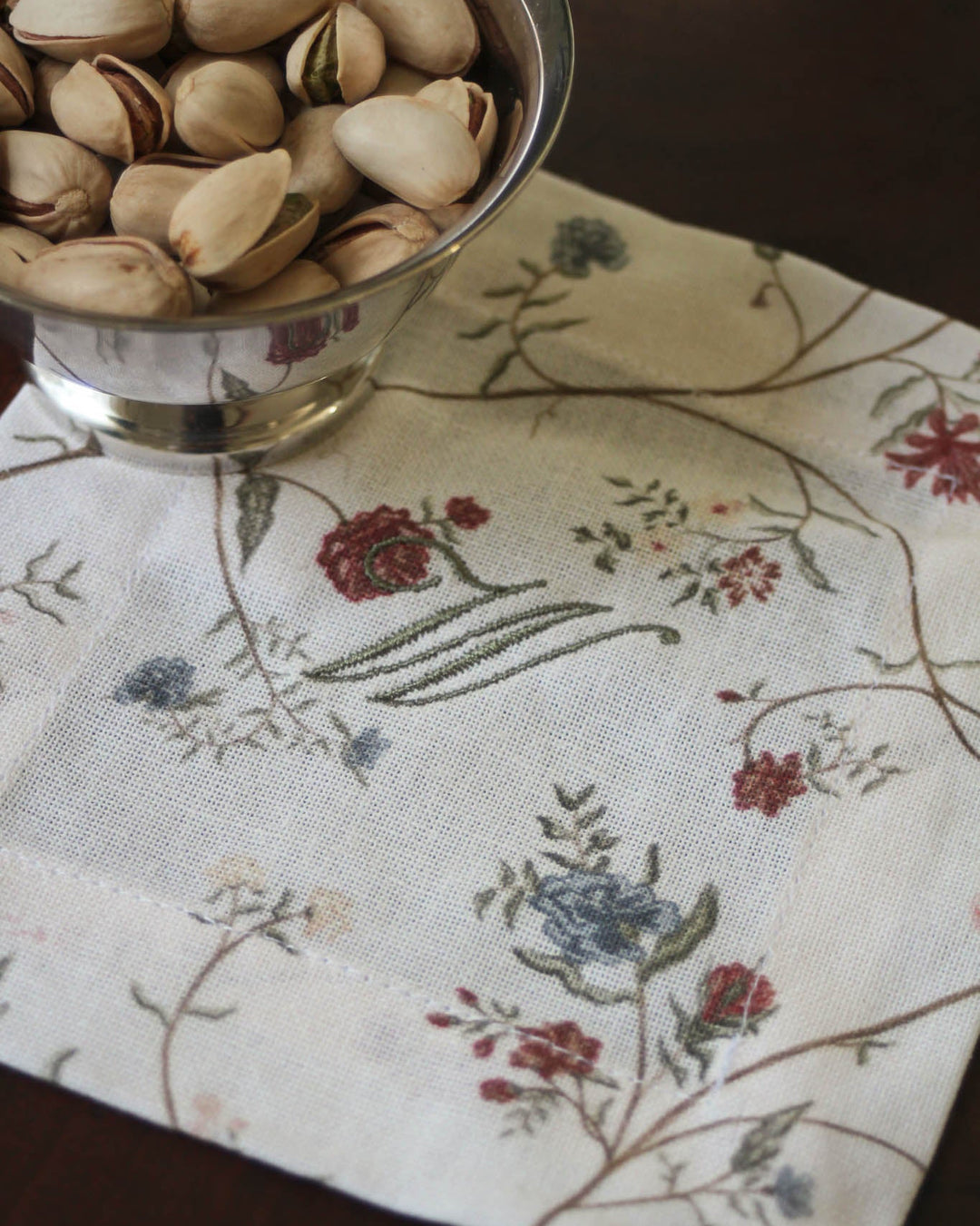 Set of four cotton cocktail napkins featuring a hand-drawn floral print, perfect for drinks, appetizers, and everyday entertaining.