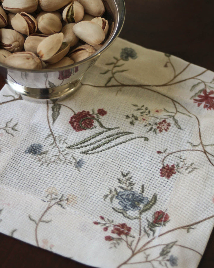 Set of four cotton cocktail napkins featuring a hand-drawn floral print, perfect for drinks, appetizers, and everyday entertaining.