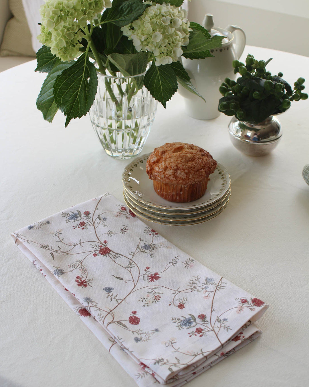 Printed kitchen towel featuring a hand-drawn botanical motif, perfect for displaying on an oven handle or gifting to a host.