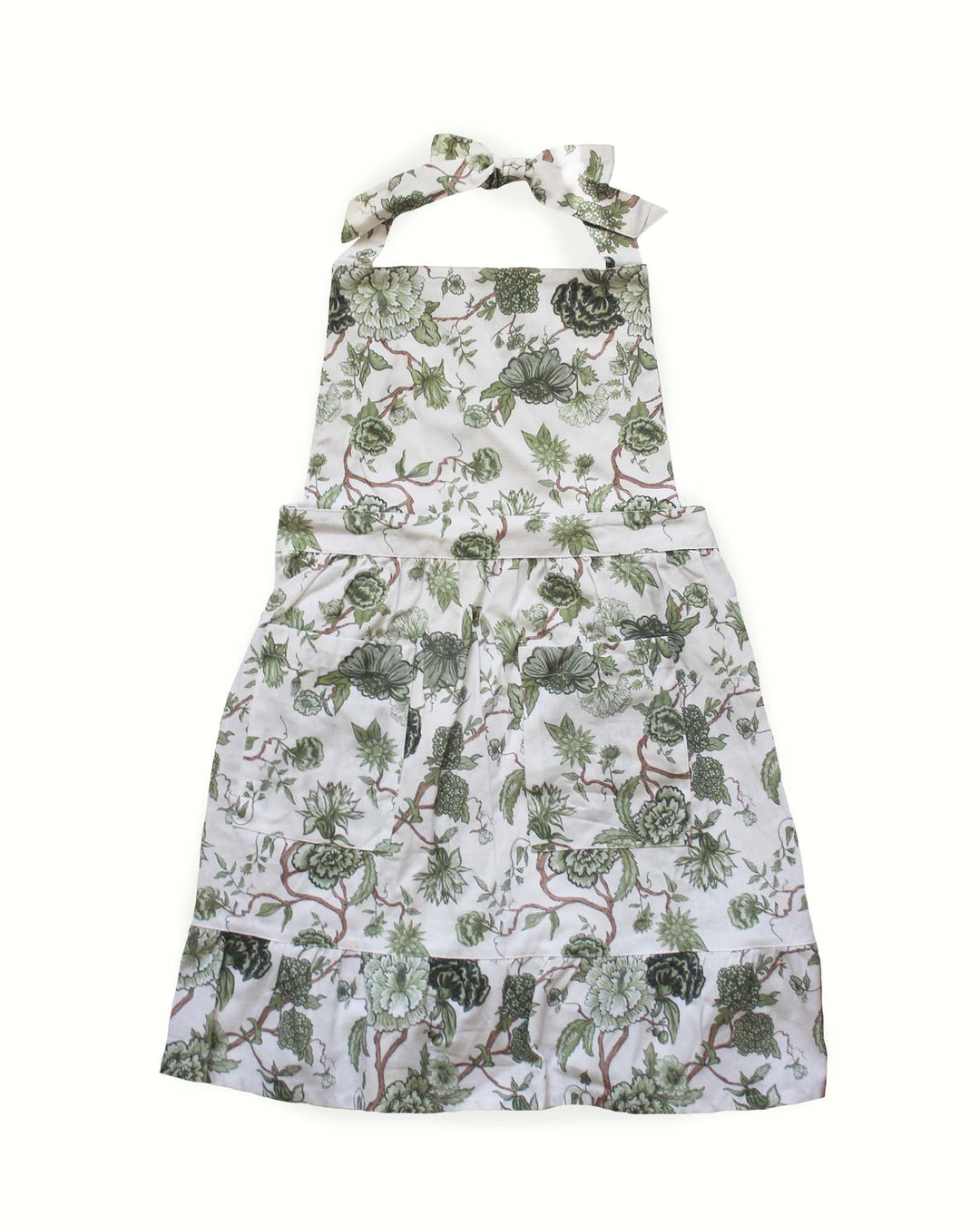 Hand-drawn floral green cotton apron with two front pockets, ruffle hem and adjustable ties, designed for home cooks, bakers, and kitchen hosting. Made with 100% cotton. 