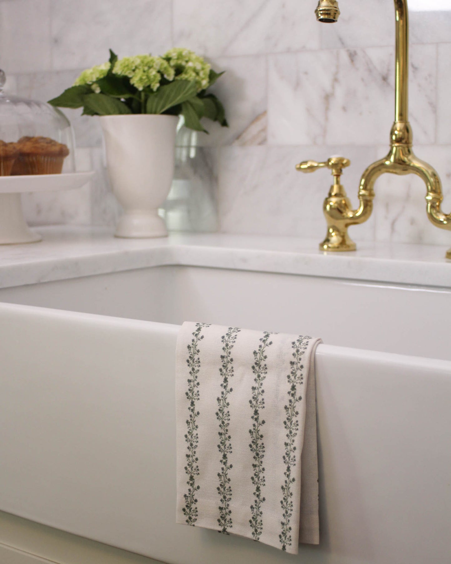 Begonia floral tea towel draped over oven handle for Thanksgiving entertaining