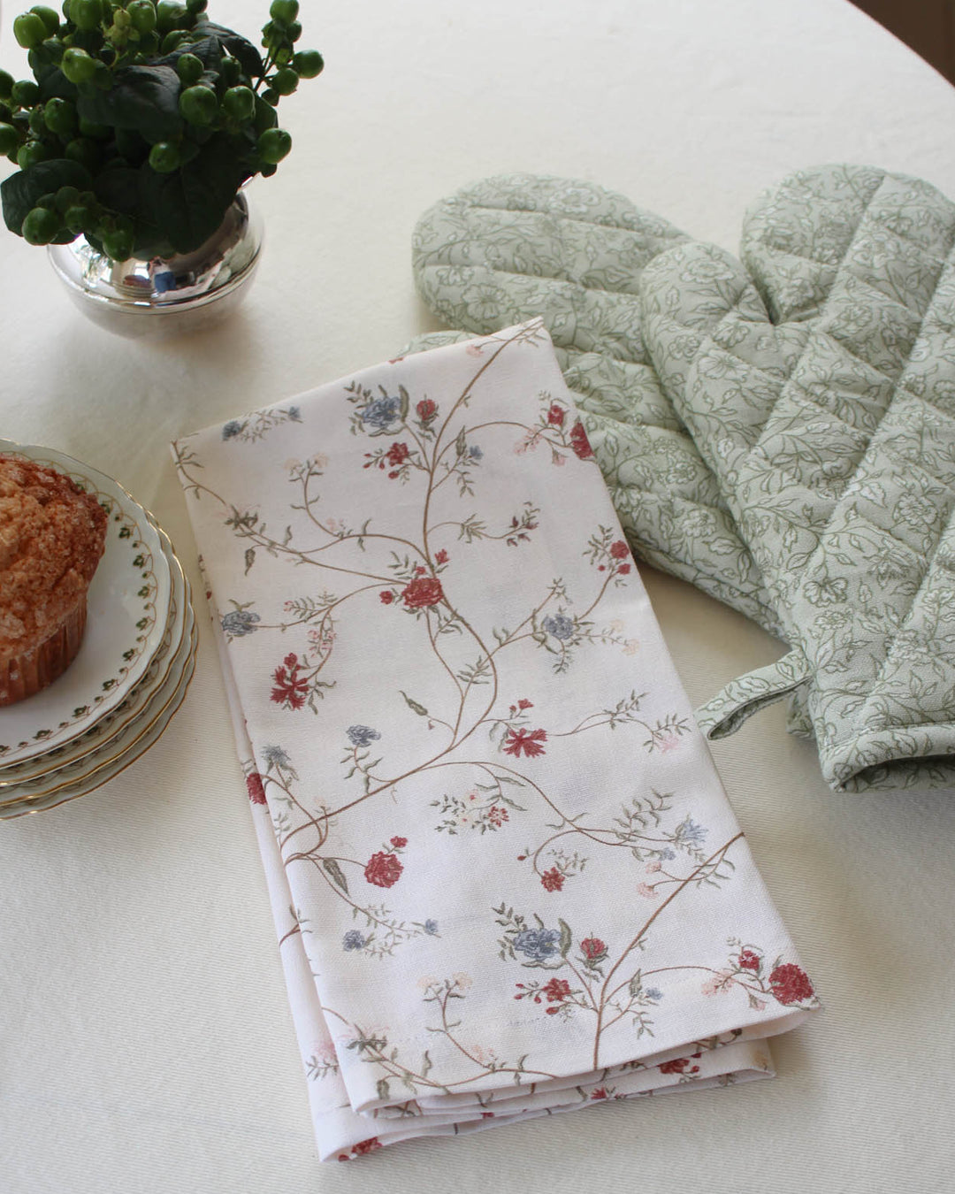 Cotton tea towel featuring a hand-drawn floral print, perfect for drying dishes, lining baskets, and adding timeless style to the kitchen.