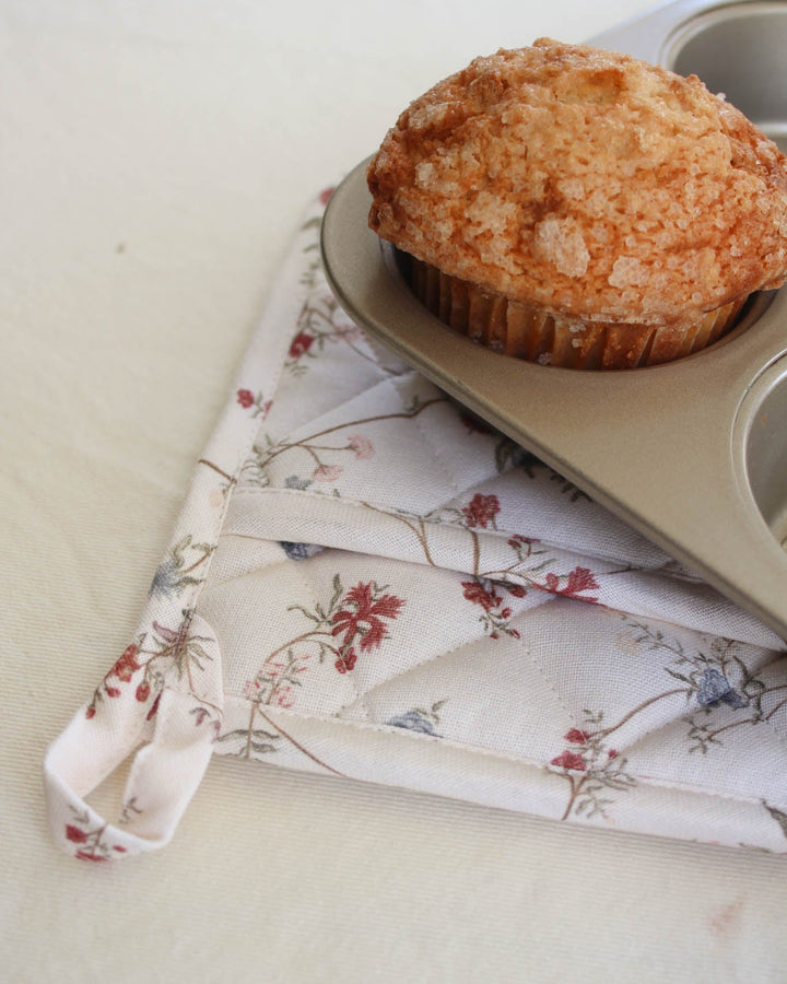Hand-drawn botanical print pot holder crafted from quilted cotton, offering practical protection for handling hot pots, pans, and baking dishes.