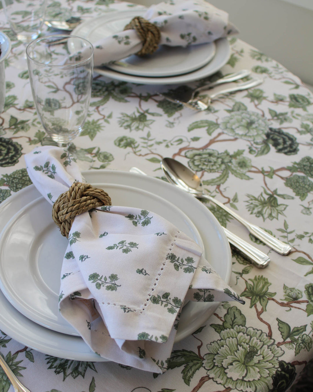 Elevate your spring table decor with these exquisite hemstitched napkins in a set of 4. Featuring lush green floral napkins with botanical illustrations, these cotton dinner napkins are perfectly sized at 20 inches square for formal and casual table settings. Ideal for rehearsal dinner napkins or elegant napkins for wedding decor. These reusable napkins are a thoughtful new home gift or gift for mom, grandma, and aunt. Pairs beautifully with coordinating green floral tablecloths.