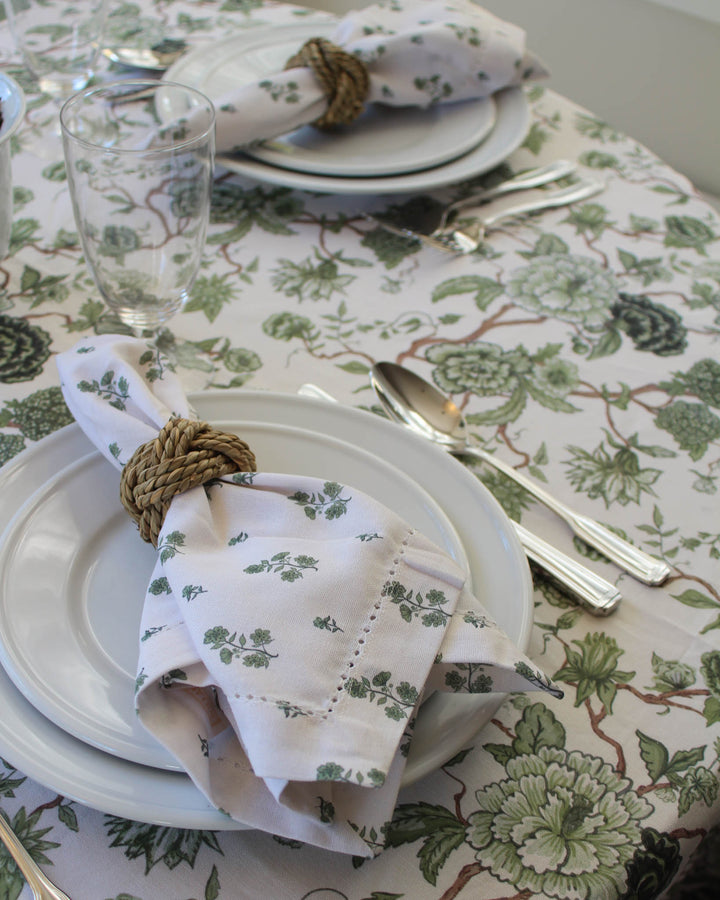 Elevate your spring table decor with these exquisite hemstitched napkins in a set of 4. Featuring lush green floral napkins with botanical illustrations, these cotton dinner napkins are perfectly sized at 20 inches square for formal and casual table settings. Ideal for rehearsal dinner napkins or elegant napkins for wedding decor. These reusable napkins are a thoughtful new home gift or gift for mom, grandma, and aunt. Pairs beautifully with coordinating green floral tablecloths.