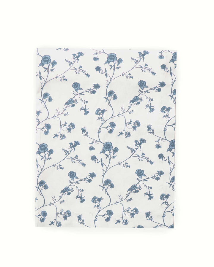 Floral patterned tablecloth with blue flowers on a white background