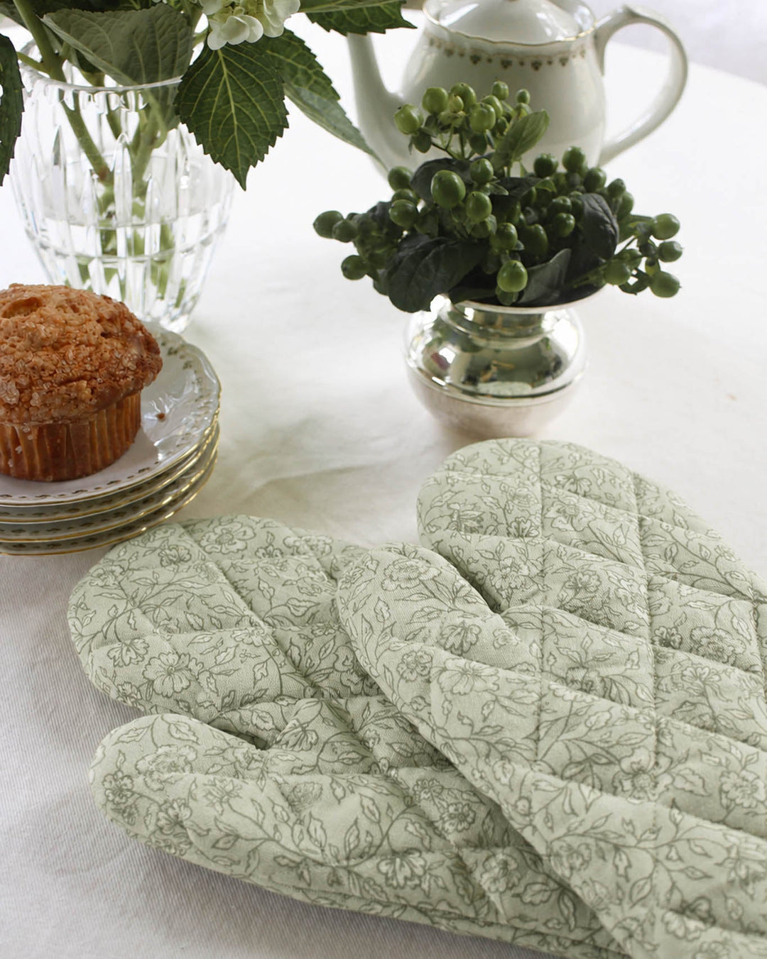 Quilted cotton oven mitt featuring a hand-drawn floral print, designed to protect hands while cooking, baking, and handling hot cookware.