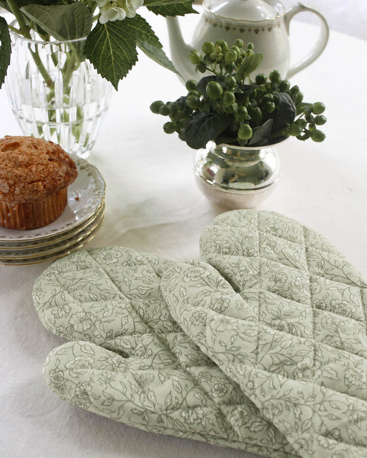 Quilted cotton oven mitt featuring a hand-drawn floral print, designed to protect hands while cooking, baking, and handling hot cookware.
