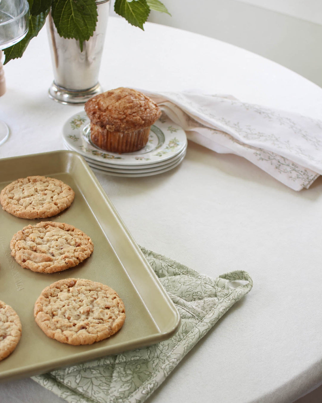 Quilted floral cotton pot holder with a heat-resistant design and hanging loop, made for baking, cooking, and displaying in a beautiful kitchen.