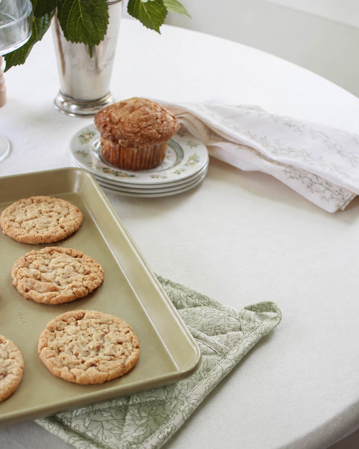 Quilted floral cotton pot holder with a heat-resistant design and hanging loop, made for baking, cooking, and displaying in a beautiful kitchen.