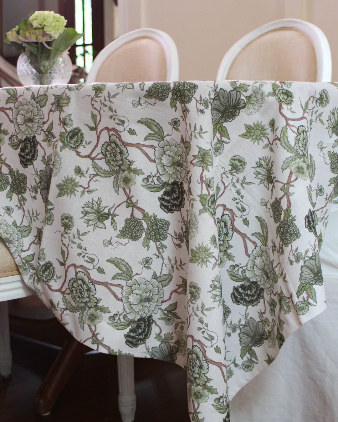 Green Tablecloth Rectangle available in 66x104 and 66x120 inch sizes. Featuring a French Country print with hand-drawn green flowers, this Cotton Tablecloth is perfect for Easter Table Decor or a Mother's Day Brunch. The Grand Millennial Decor style offers an elegant drape for long tables. Use this Floral Tablecloth to bring cheer to your dining room while complementing your china. Ideal as a Spring Tablecloth for large family gatherings and holiday hosting.