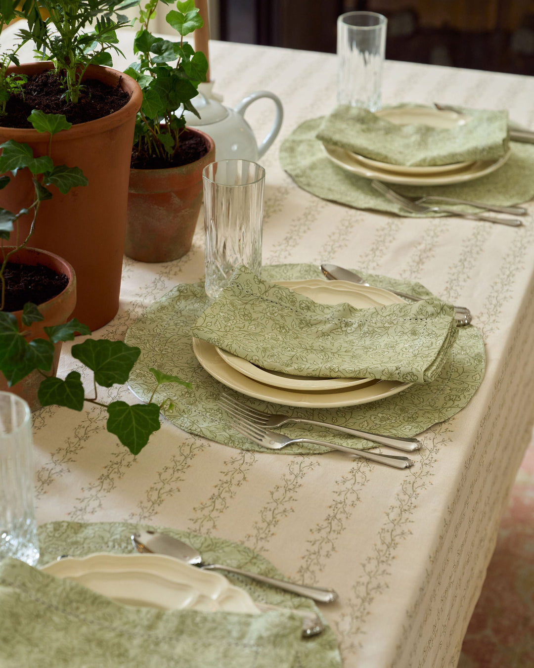 Neutral spring and fall tablecloth featuring a delicate sage green and pale yellow floral stripe inspired by English garden textiles.