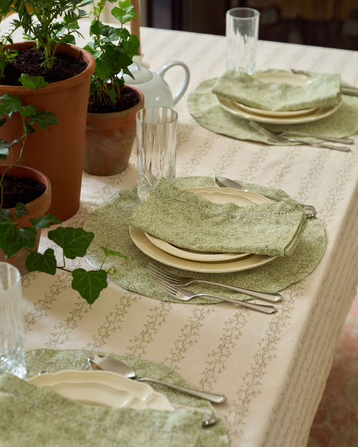 Neutral spring and fall tablecloth featuring a delicate sage green and pale yellow floral stripe inspired by English garden textiles.