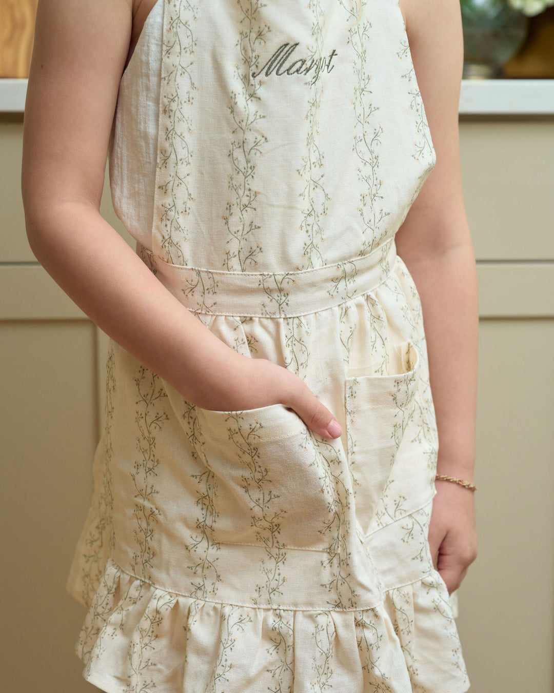 Personalized children’s floral apron for ages 4–7 with optional monogramming, adjustable waist ties, and pockets for Christmas cookies, holiday cooking, and matching moments with mom.