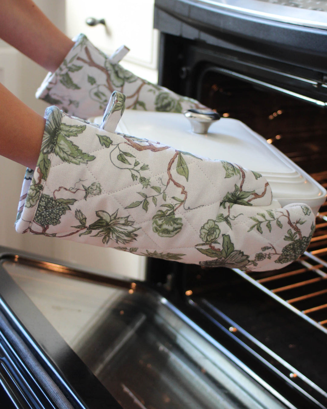 Floral kitchen gloves with soft quilted texture, designed for comfort and protection while cooking and serving.